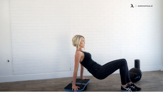 Explosive jump training on a balance board for enhanced neuromuscular response.