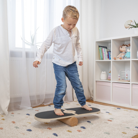 Kids using a balance board to strengthen their body and sensory integration.