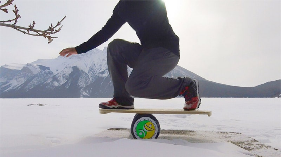 Using a balance board to simulate weight transfer for skiing preparation.