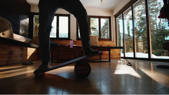 Office worker using a balance board to improve core stability