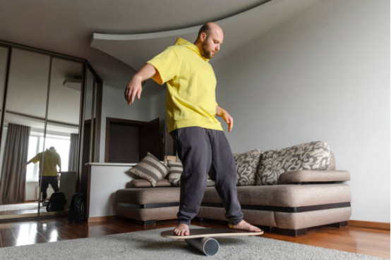 An adult performing dynamic balance exercises on a balance board