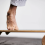 Close-up of foot on a wooden balance board with cork roller.