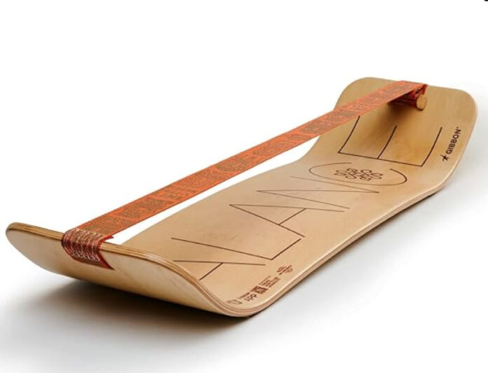 Curved wooden balance board with an orange strap, designed for stability.