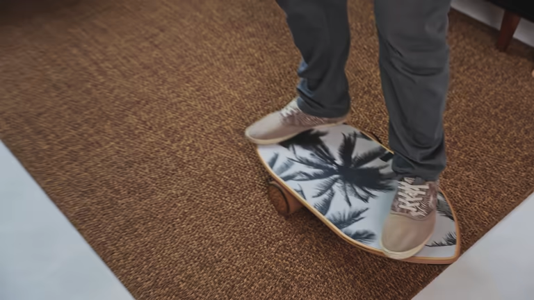 Person standing on a tropical design surf-style balance board for balance training.